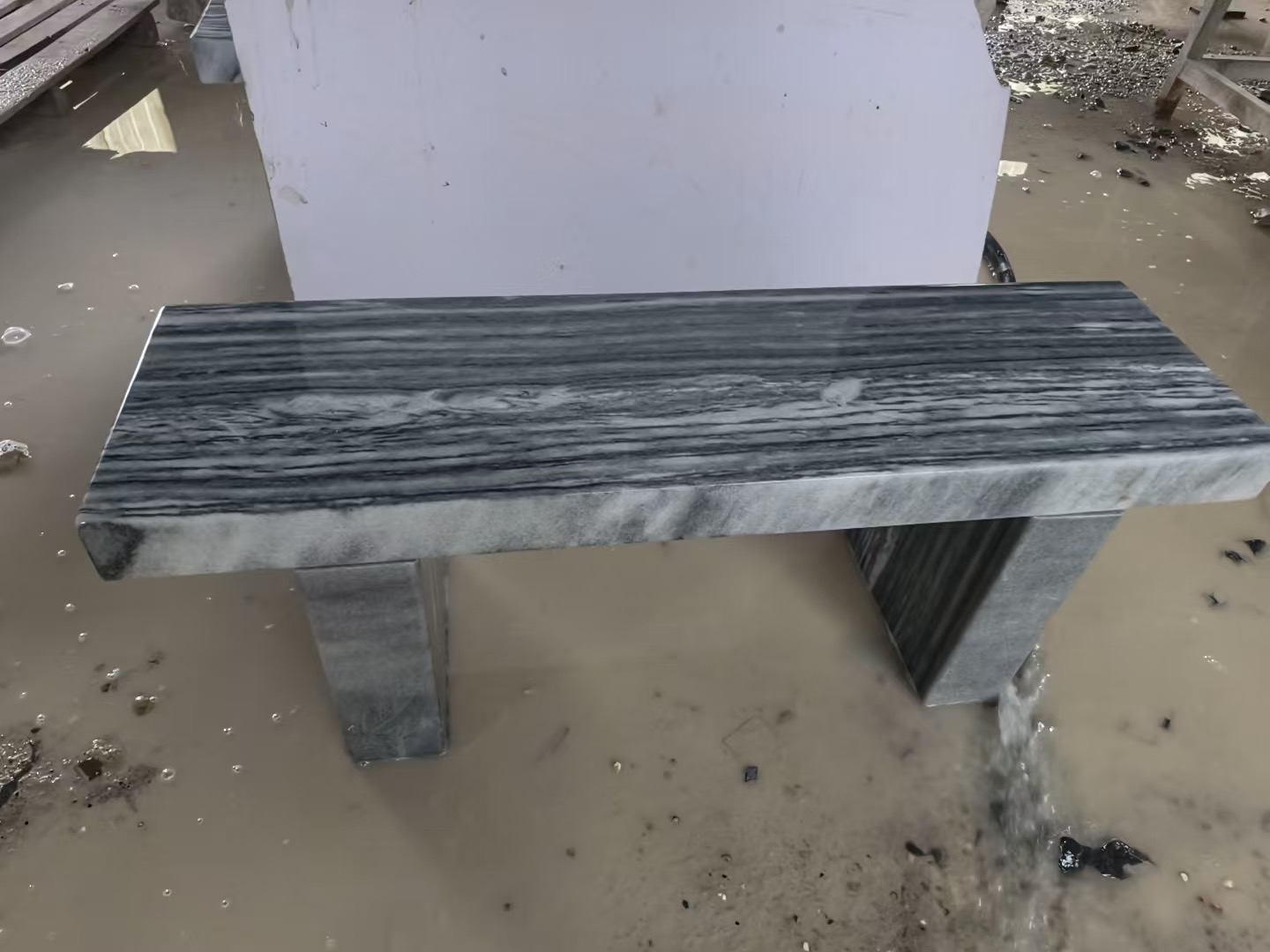 Straight-line dark stone bench