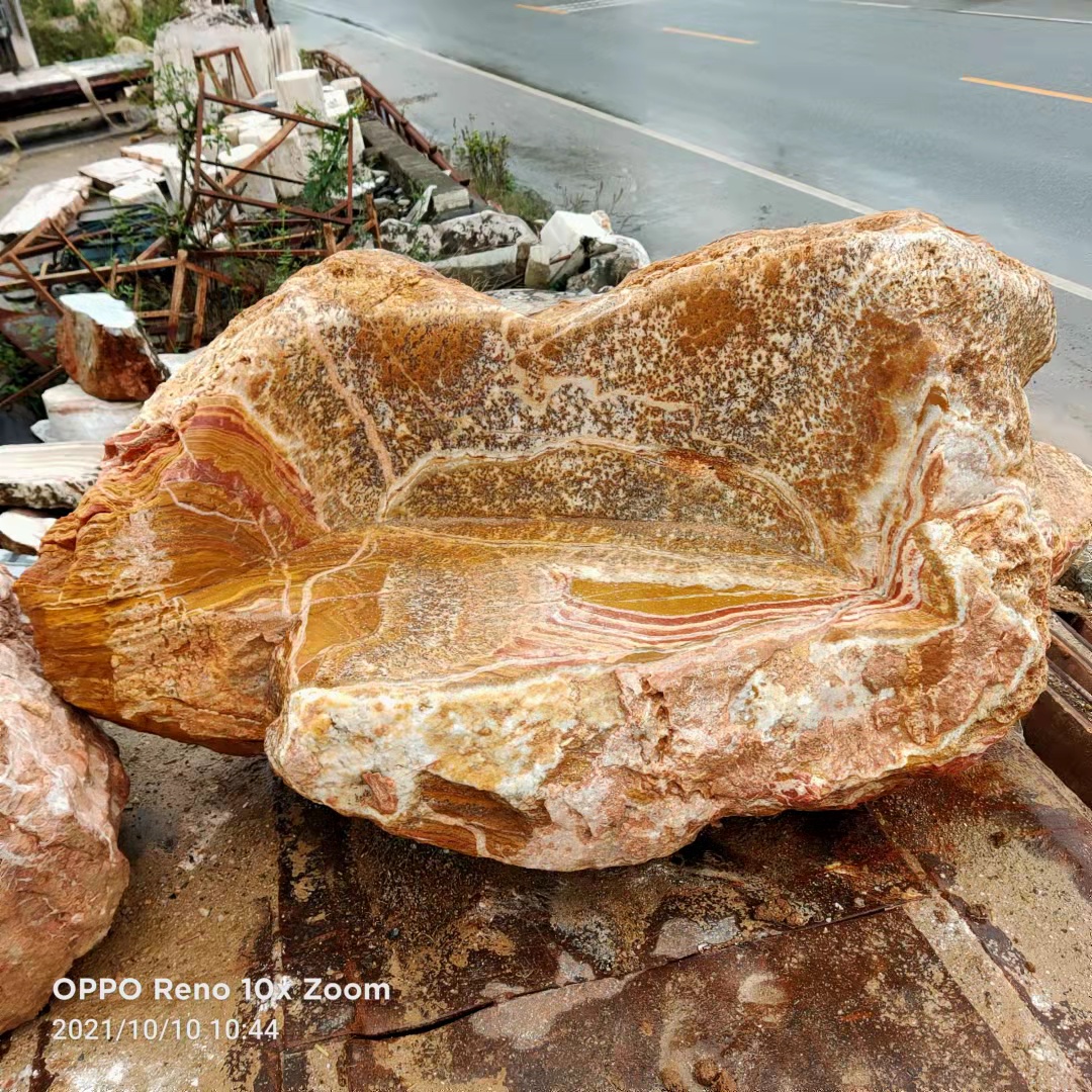 Sculptural stone seat with a backrest