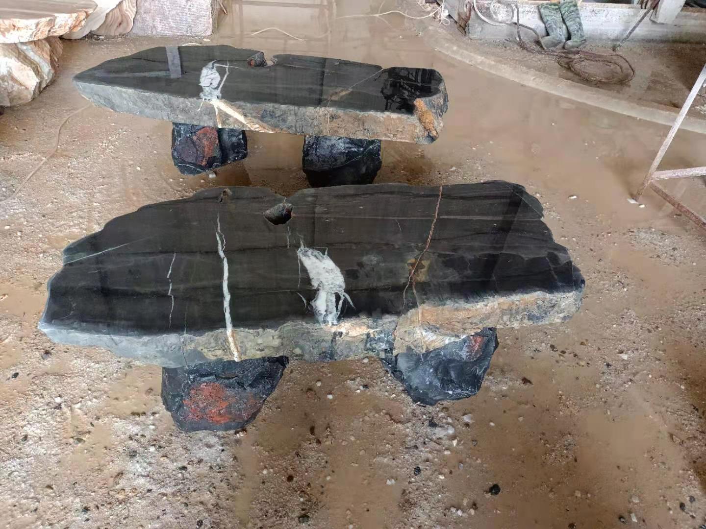 Dark stone benches — paired view