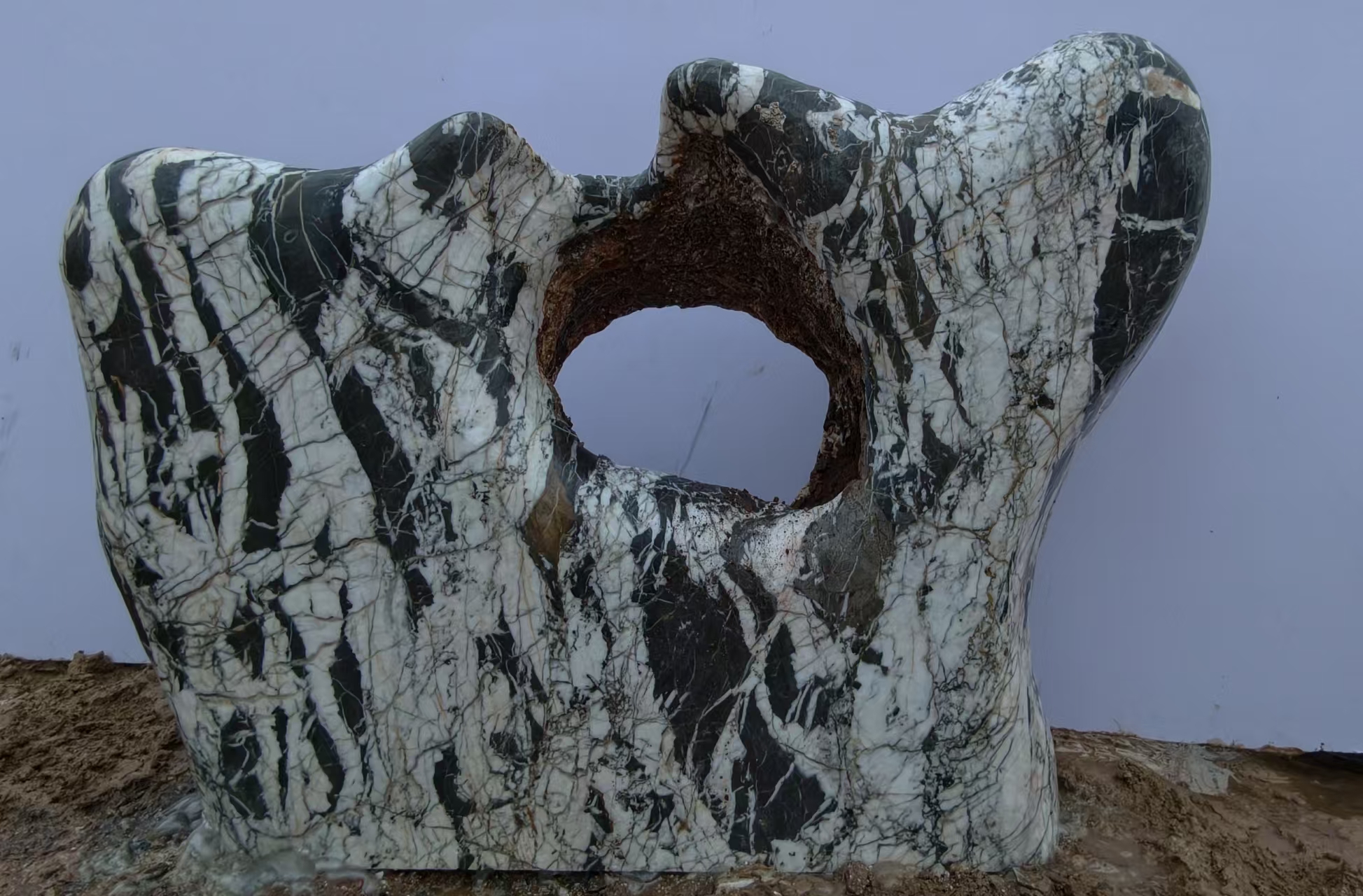 Dark striped stone with a round opening