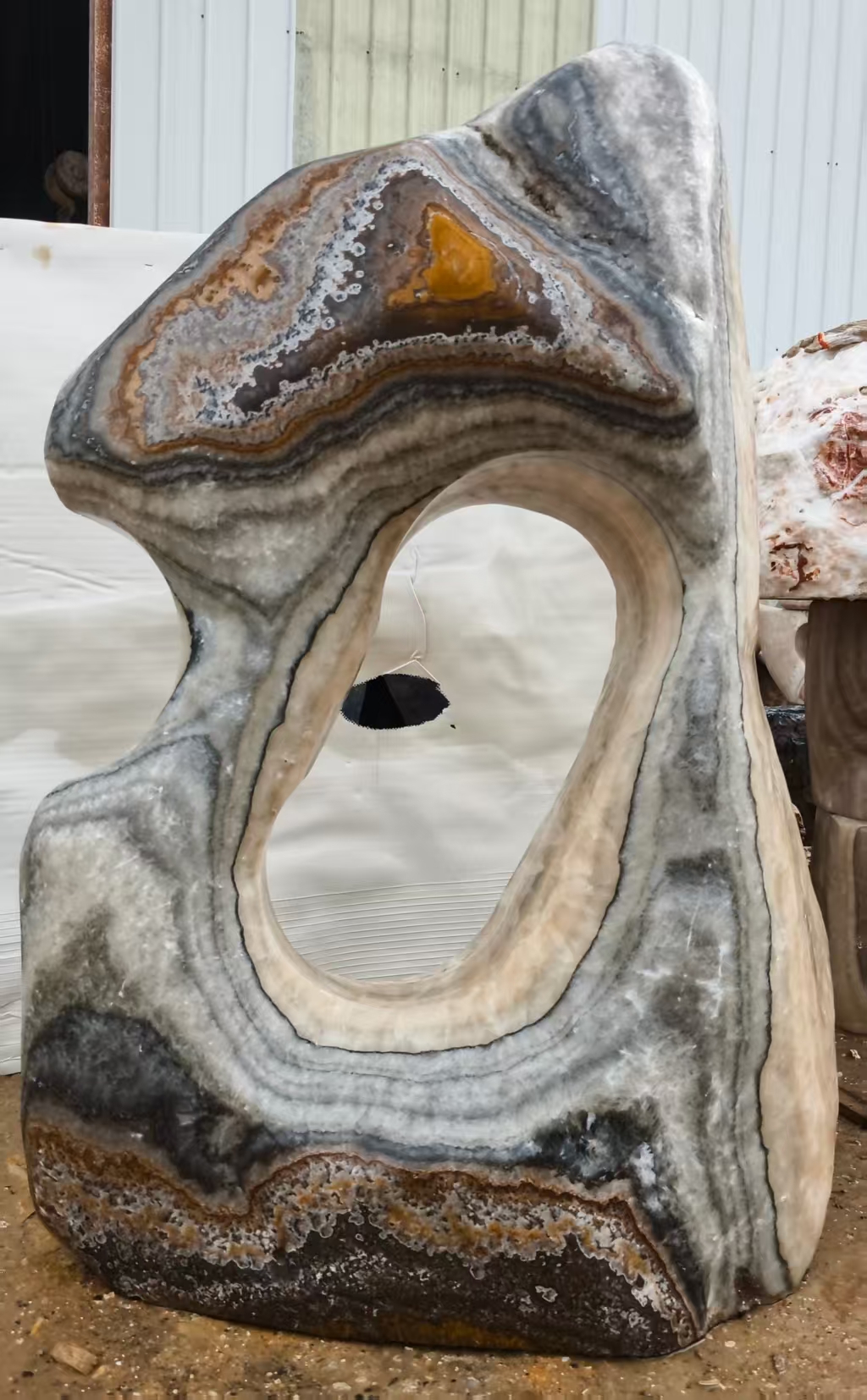 Banded stone with a curved opening