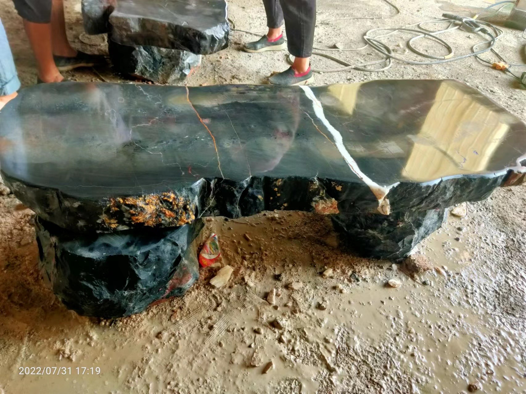 Dark stone bench with contrasting veins