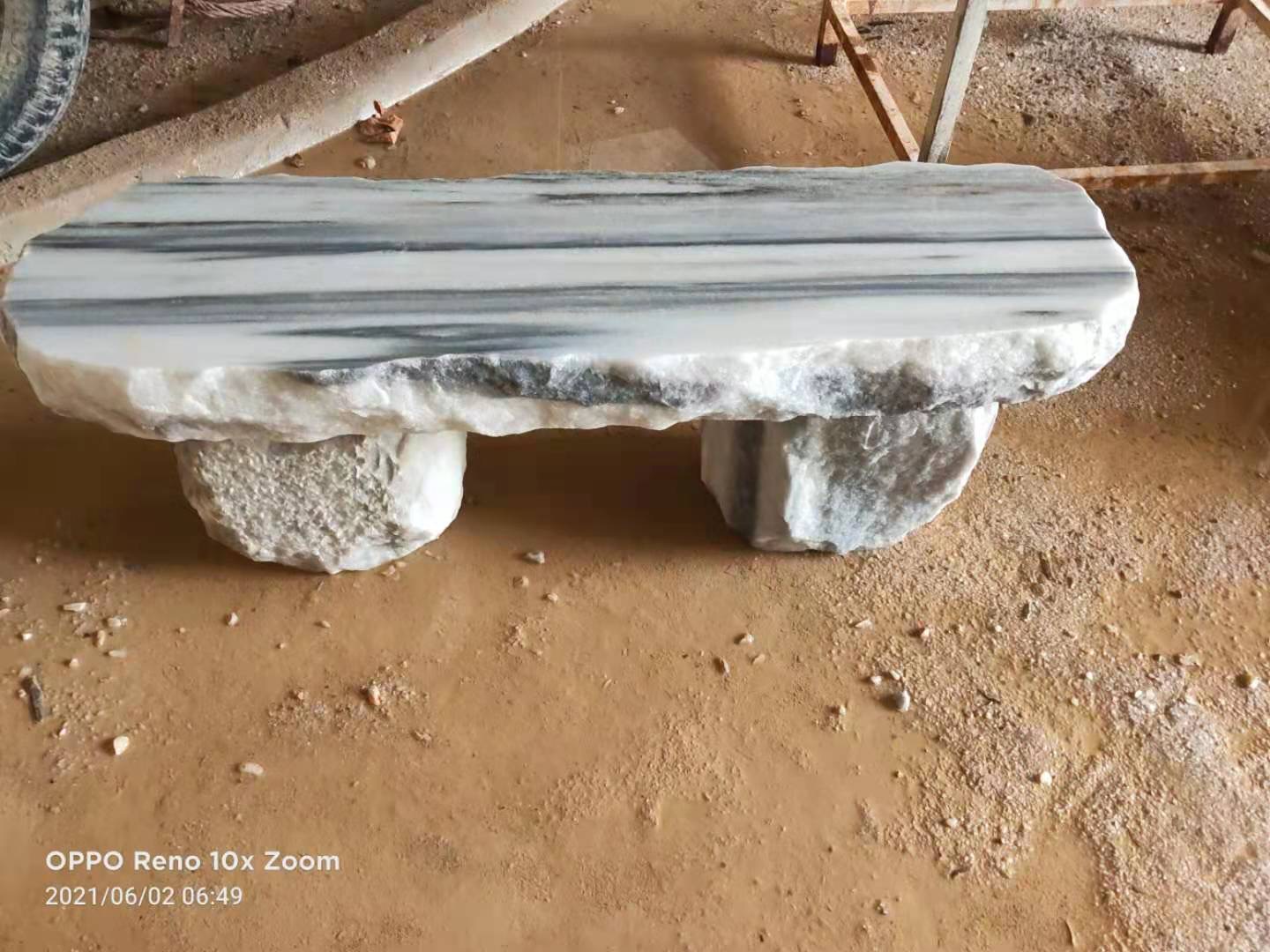 Light stone bench with natural edges