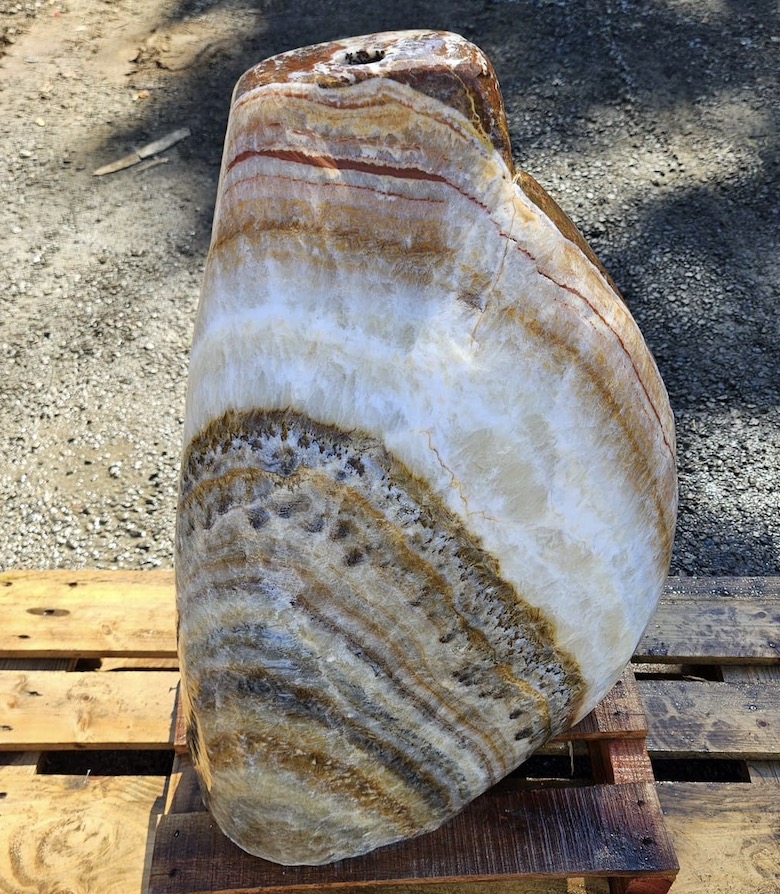 Natural stone with cream, gold and red banded veining