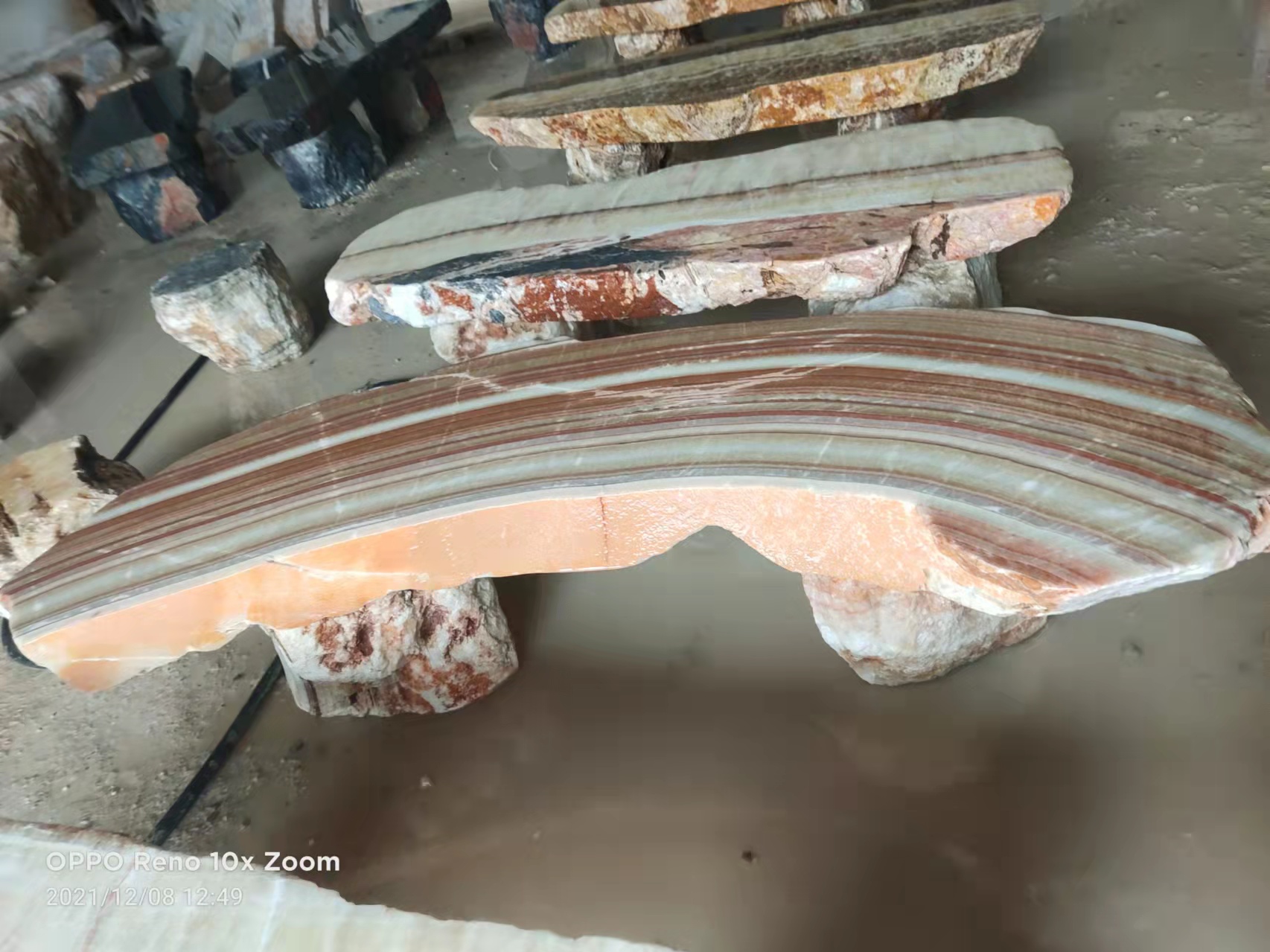 Curved stone bench with banded veining
