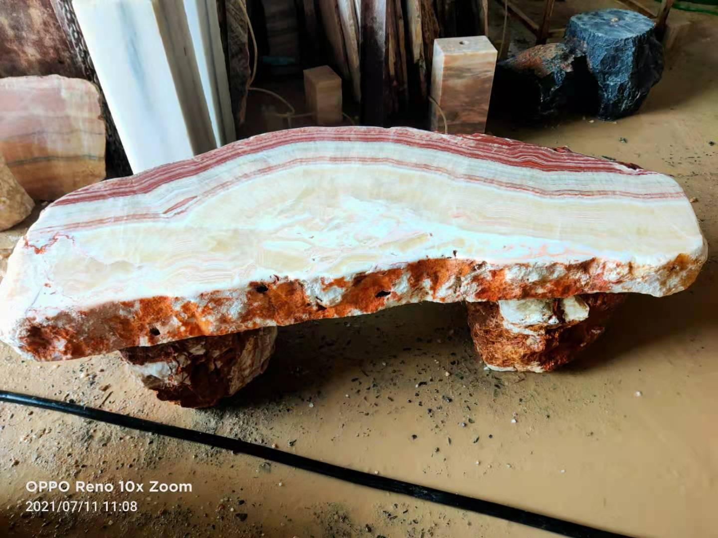 Stone bench with curved natural bands